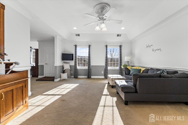 living room with crown molding, light colored carpet, ceiling fan, and visible vents