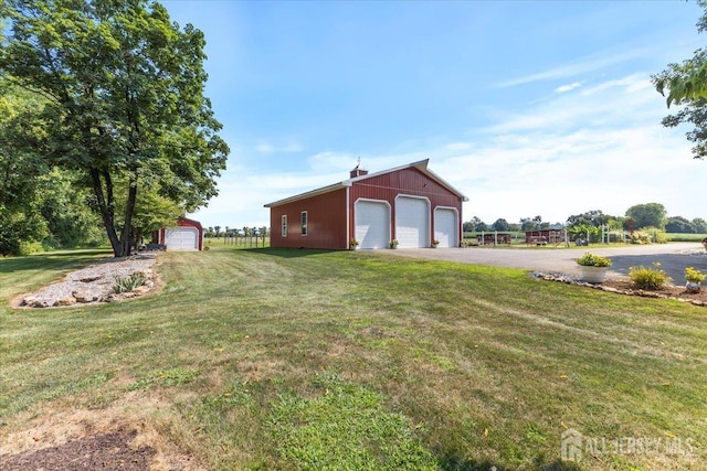 exterior space featuring an outbuilding and driveway