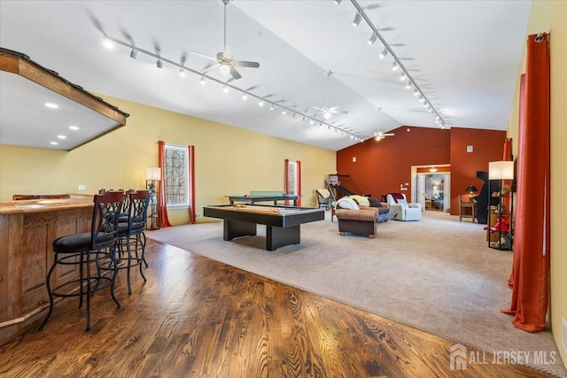 rec room featuring track lighting, a ceiling fan, billiards, lofted ceiling, and a bar