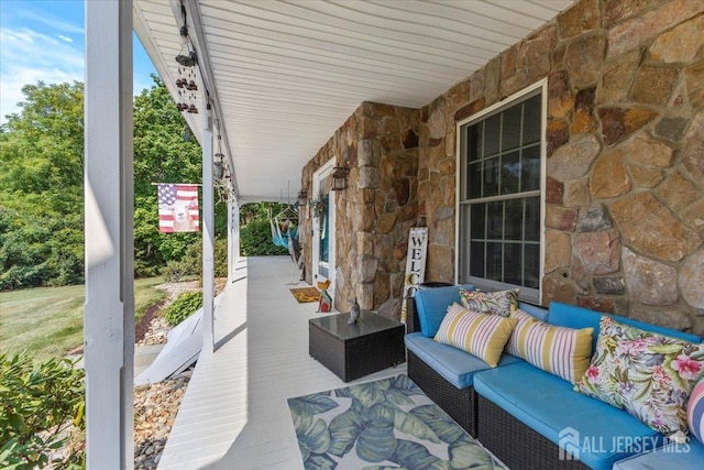 view of patio featuring covered porch and outdoor lounge area