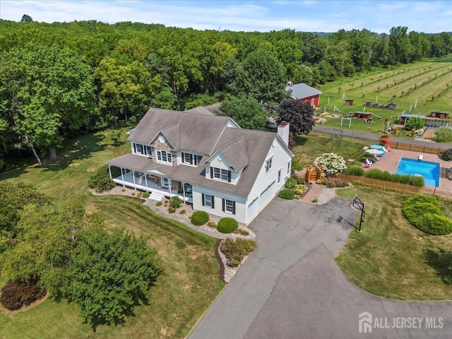 drone / aerial view with a wooded view