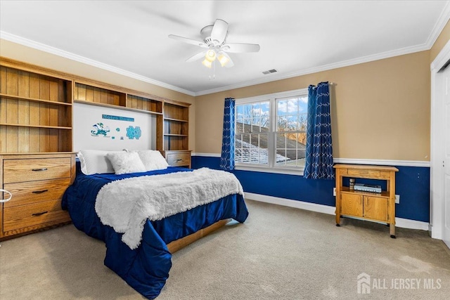 carpeted bedroom featuring baseboards, ceiling fan, visible vents, and crown molding