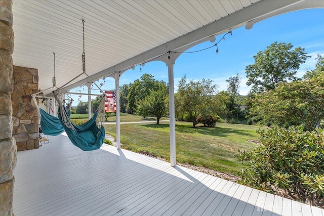 wooden deck featuring a lawn