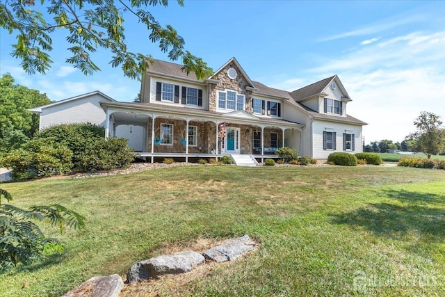 view of front of property featuring a porch, a front yard, and stone siding