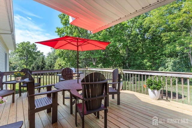 wooden deck featuring outdoor dining area
