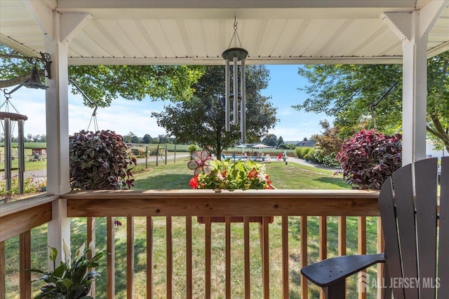 wooden terrace with a yard