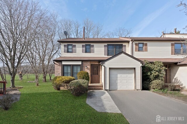 view of front of property featuring a garage and a front yard