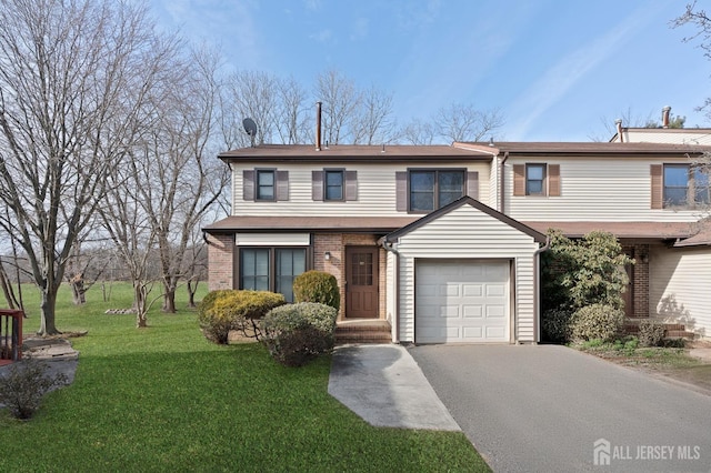 view of front of property featuring a garage and a front yard