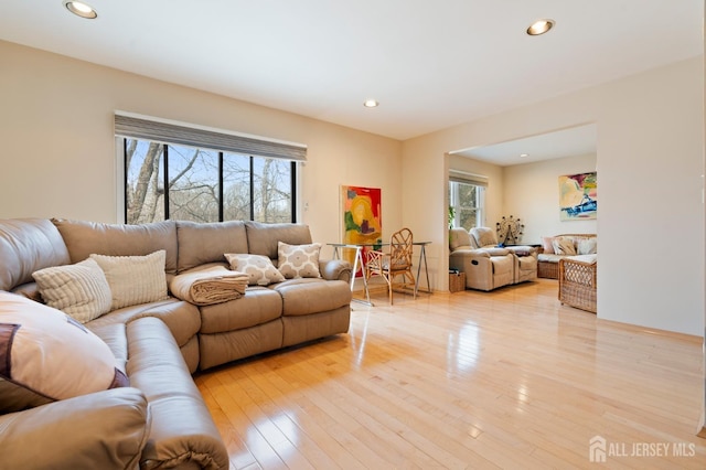 living room with light wood-style flooring and recessed lighting