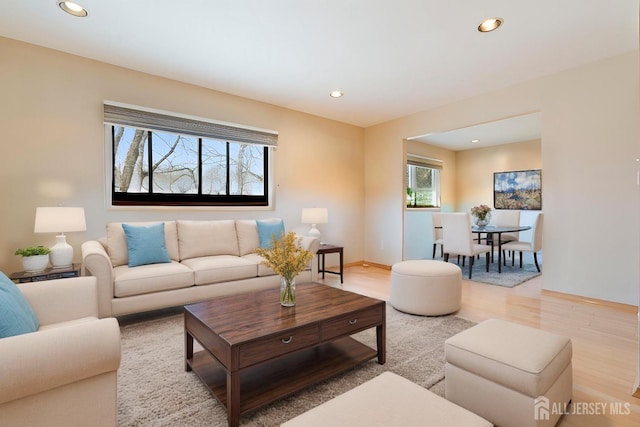 living room with baseboards, light wood-type flooring, and recessed lighting