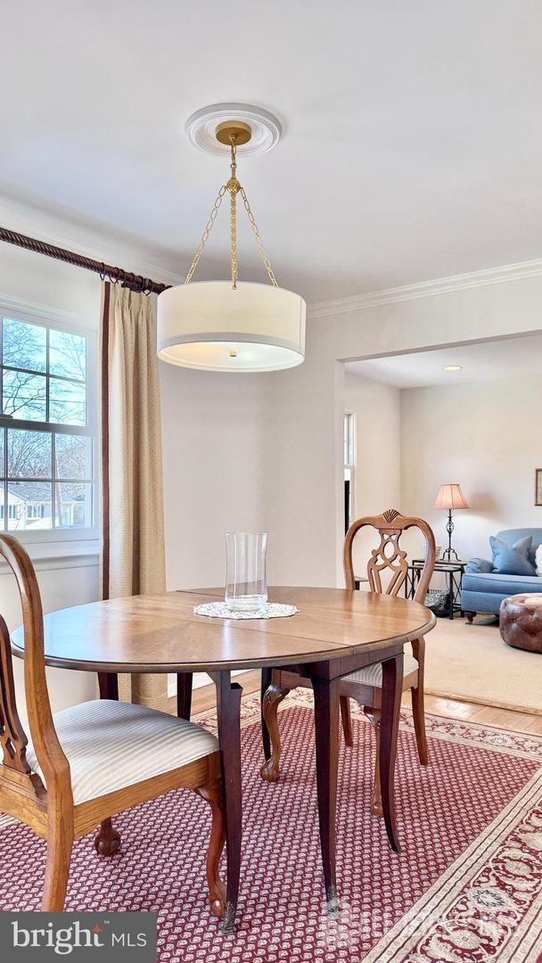 dining space with crown molding