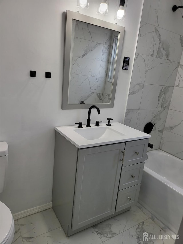 bathroom featuring baseboards, toilet, shower / bath combination, marble finish floor, and vanity