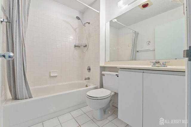 full bathroom with shower / tub combo, vanity, tile patterned floors, and toilet