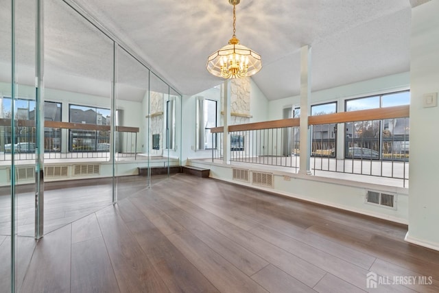 unfurnished sunroom with lofted ceiling and a chandelier