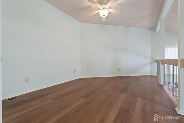 empty room with ceiling fan, wood-type flooring, and lofted ceiling with beams