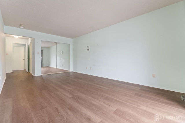 unfurnished room featuring light wood-type flooring