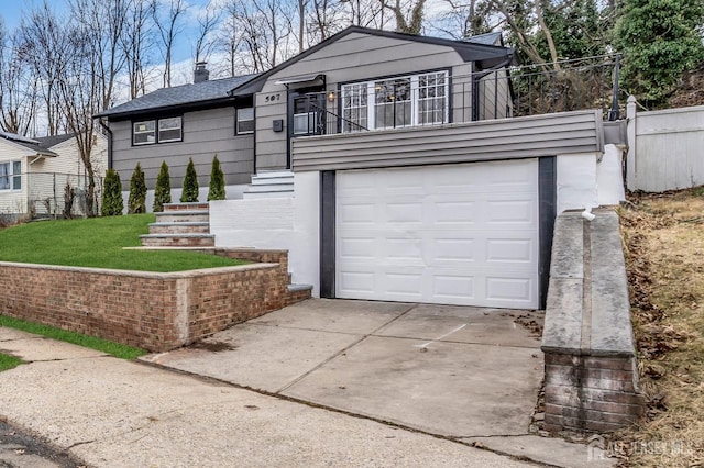 view of front of home featuring an attached garage, a balcony, fence, concrete driveway, and a chimney