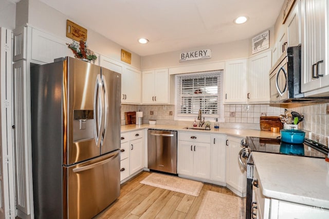 17 Morningside Dr, Old Bridge, NJ 08857 - kitchen featuring white cabinetry, light wood-style flooring, appliances with stainless steel finishes, and a sink
