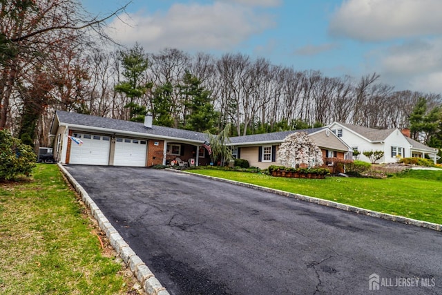 17 Morningside Dr, Old Bridge, NJ 08857 - single story home featuring aphalt driveway, a garage, a front lawn, and a chimney