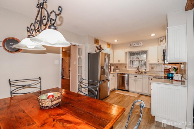 17 Morningside Dr, Old Bridge, NJ 08857 - kitchen featuring light wood finished floors, stainless steel appliances, white cabinetry, backsplash, and recessed lighting