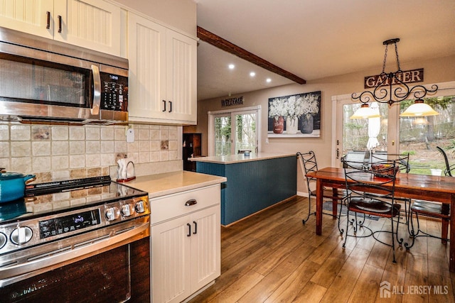 17 Morningside Dr, Old Bridge, NJ 08857 - kitchen with stainless steel appliances, wood finished floors, recessed lighting, light countertops, and decorative backsplash