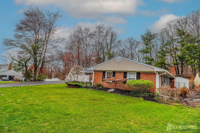 17 Morningside Dr, Old Bridge, NJ 08857 - view of side of home with a lawn, brick siding, and aphalt driveway