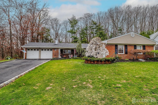 17 Morningside Dr, Old Bridge, NJ 08857 - ranch-style home featuring a chimney, brick siding, an attached garage, aphalt driveway, and a front lawn