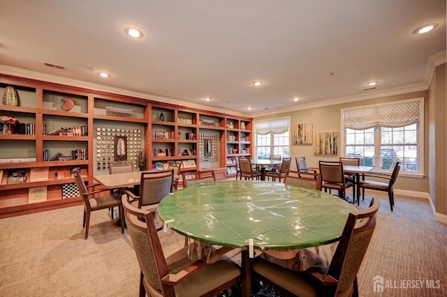 dining area featuring light colored carpet, visible vents, crown molding, and recessed lighting