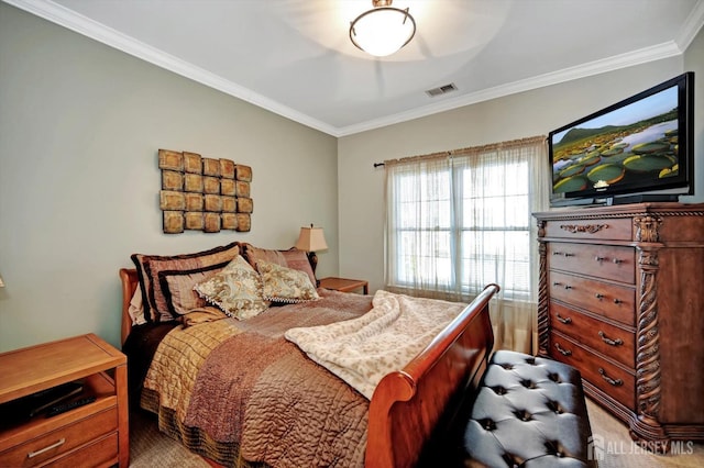 bedroom with visible vents and crown molding