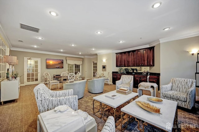 living area with light carpet, visible vents, crown molding, and recessed lighting