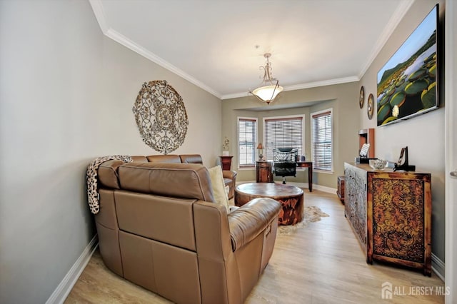 living area with ornamental molding, light wood-type flooring, and baseboards