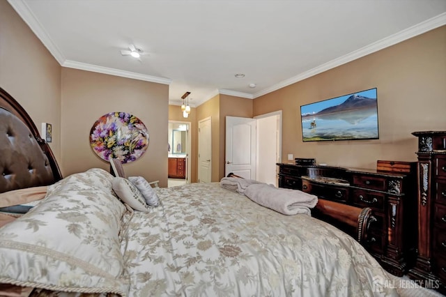 bedroom featuring crown molding and ensuite bath