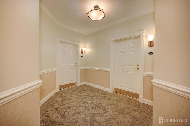 interior space with a wainscoted wall, carpet, and ornamental molding