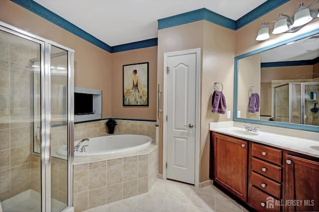 full bathroom with double vanity, tile patterned floors, a sink, a shower stall, and a bath