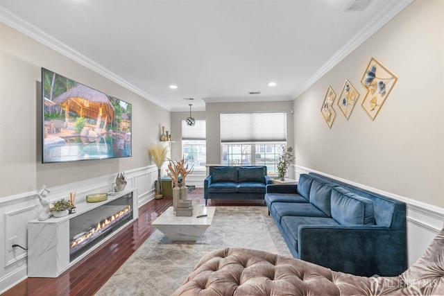 living room with ornamental molding and hardwood / wood-style flooring