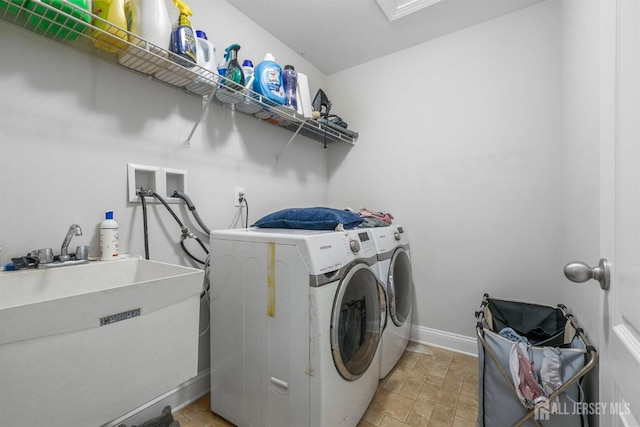 laundry area with sink and independent washer and dryer