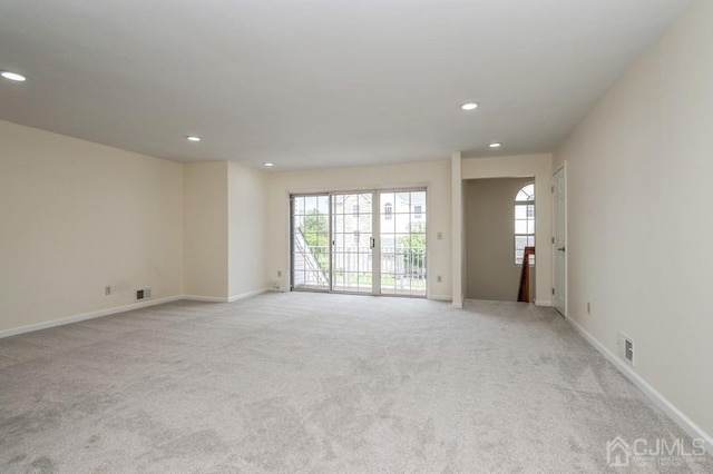 carpeted spare room featuring a wealth of natural light