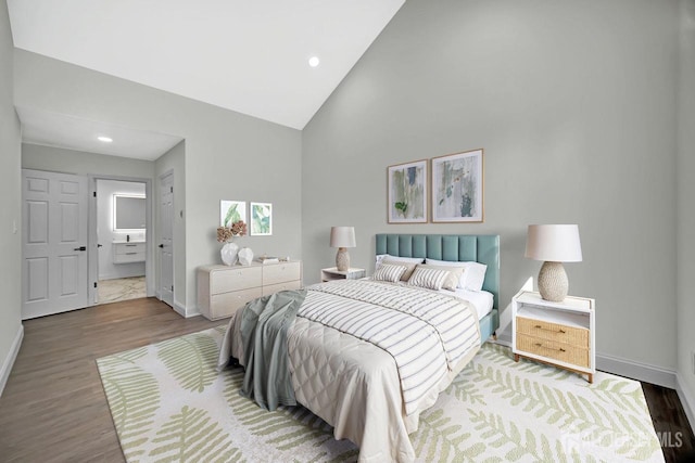 bedroom featuring baseboards, wood finished floors, high vaulted ceiling, and recessed lighting