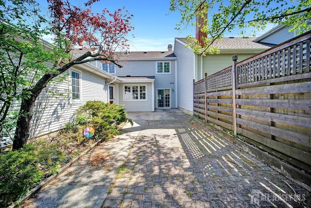 back of house with fence and a patio