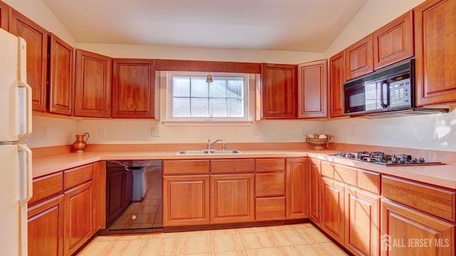 kitchen featuring lofted ceiling, sink, black appliances, and light tile patterned floors