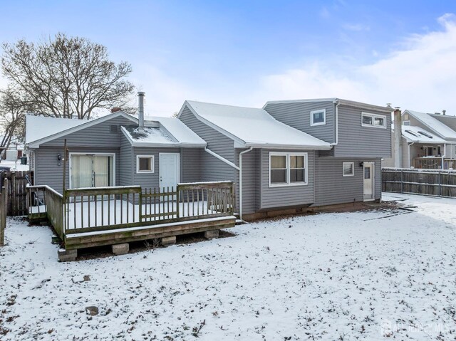 view of snow covered rear of property