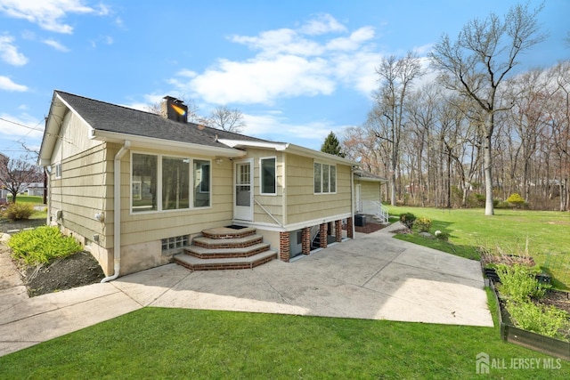 46 Thomas St, Monroe, NJ 08831 - back of house featuring a yard and a chimney