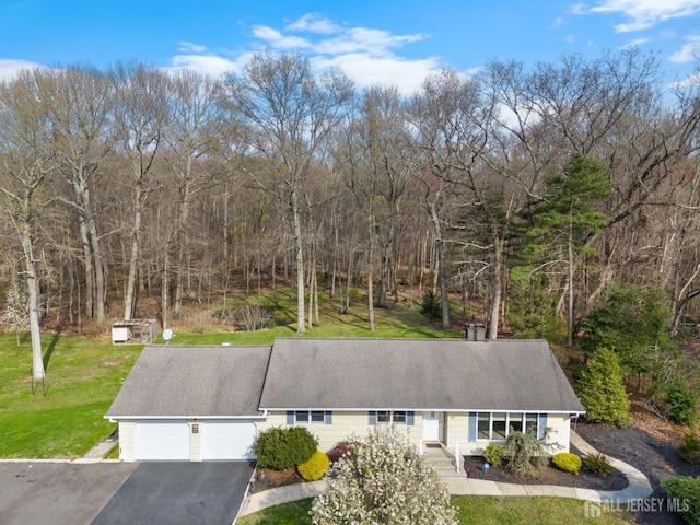 46 Thomas St, Monroe, NJ 08831 - view of front facade with an attached garage, asphalt driveway, and a front lawn