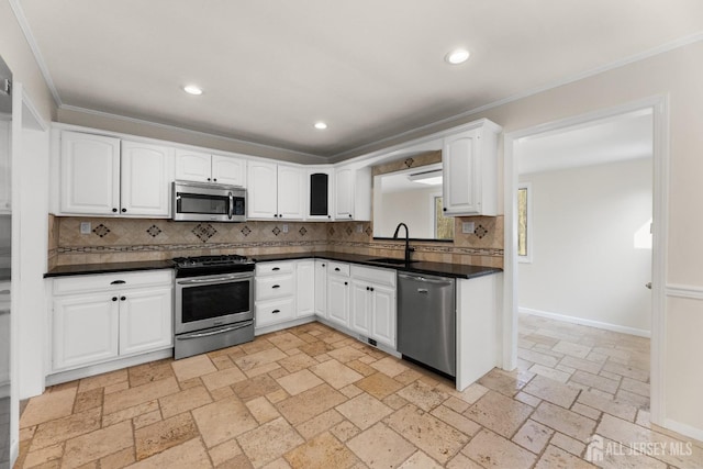 46 Thomas St, Monroe, NJ 08831 - kitchen with stainless steel appliances, a sink, dark countertops, decorative backsplash, and ornamental molding