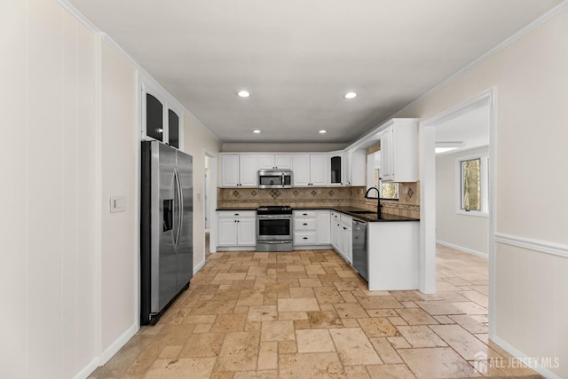 46 Thomas St, Monroe, NJ 08831 - kitchen with stainless steel appliances, dark countertops, backsplash, white cabinetry, and a sink
