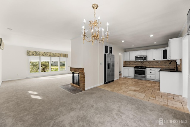 46 Thomas St, Monroe, NJ 08831 - kitchen with appliances with stainless steel finishes, open floor plan, baseboards, dark countertops, and white cabinetry