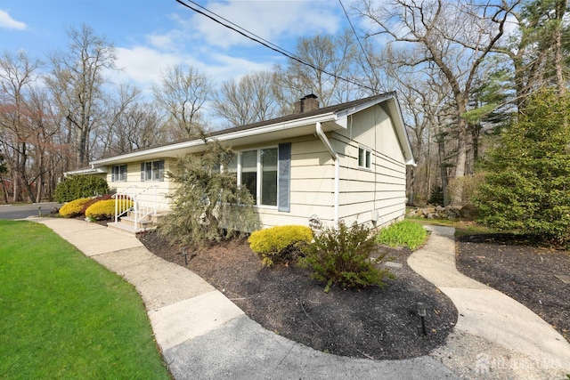 46 Thomas St, Monroe, NJ 08831 - view of home's exterior with a chimney