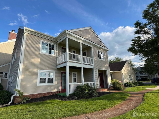 38 Rutland Ln Unit I, Monroe, NJ 08831 - view of front of home featuring a balcony, covered porch, and a front lawn