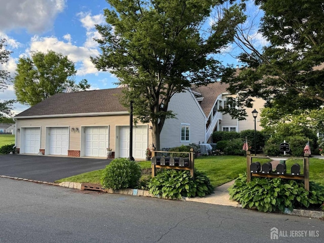 38 Rutland Ln Unit I, Monroe, NJ 08831 - view of front of house with asphalt driveway, a front lawn, an attached garage, and roof with shingles
