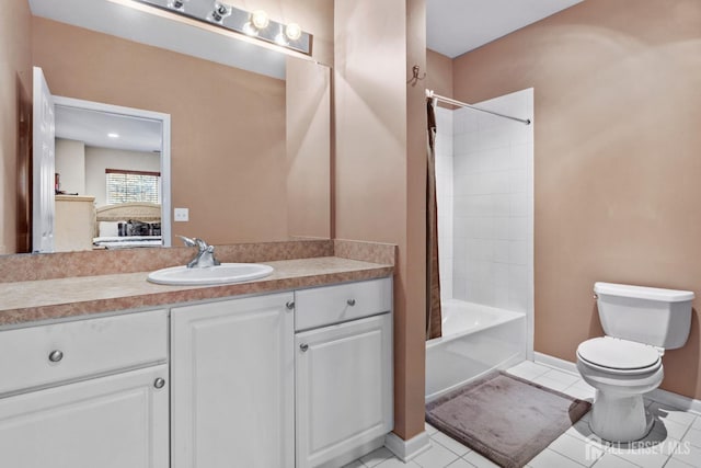 full bathroom featuring washtub / shower combination, toilet, vanity, and tile patterned flooring